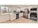 Modern kitchen with stainless steel appliances, white cabinets, and natural light at 5780 W 5Th Ave, Lakewood, CO 80226