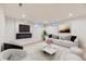 Bright living room features an electric fireplace and a modern, neutral decor at 5780 W 5Th Ave, Lakewood, CO 80226