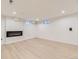 Finished basement living room with modern fireplace, recessed lighting, and wood-look floors at 5780 W 5Th Ave, Lakewood, CO 80226