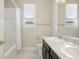 Bright bathroom featuring double sinks, white granite countertops, and a shower and tub combination at 10659 Montecito Dr, Lone Tree, CO 80124