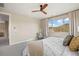 Bedroom featuring a ceiling fan, cozy seating and a window with mountain views at 10659 Montecito Dr, Lone Tree, CO 80124