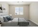 Calm bedroom featuring a large window with shutters, carpet, and soothing gray tones at 10659 Montecito Dr, Lone Tree, CO 80124