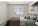 Cozy bedroom featuring large window overlooking a snow-covered landscape and comfortable grey bed at 10659 Montecito Dr, Lone Tree, CO 80124