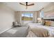 Bedroom with a scenic view, ceiling fan, and elegant furnishings for a serene retreat at 10659 Montecito Dr, Lone Tree, CO 80124