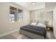Comfortable bedroom featuring a view of snow-covered ground, natural light, and a plush bed at 10659 Montecito Dr, Lone Tree, CO 80124