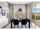 Inviting dining room featuring natural light, modern lighting, and views of the outdoors at 10659 Montecito Dr, Lone Tree, CO 80124