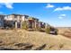 Rear view of upscale homes on a hillside with colorful exterior paint at 10659 Montecito Dr, Lone Tree, CO 80124