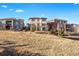 Rear view of upscale homes on a hillside with colorful exterior paint at 10659 Montecito Dr, Lone Tree, CO 80124