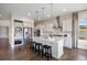 Modern kitchen with stainless steel appliances, island with seating, and ample cabinet space at 10659 Montecito Dr, Lone Tree, CO 80124