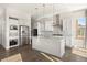 Well-lit kitchen featuring stainless steel appliances, a kitchen island, and hardwood floors at 10659 Montecito Dr, Lone Tree, CO 80124