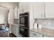 Gourmet kitchen with stainless steel double ovens and light countertops and backsplash at 10659 Montecito Dr, Lone Tree, CO 80124