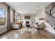 Cozy living room featuring a fireplace, built-in shelves, and large windows with views at 10659 Montecito Dr, Lone Tree, CO 80124