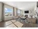 Inviting living room featuring a fireplace, large windows, hardwood floors and recessed lighting at 10659 Montecito Dr, Lone Tree, CO 80124