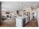 Open-concept living space with a fireplace, hardwood floors, and a view of the kitchen at 10659 Montecito Dr, Lone Tree, CO 80124