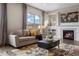 Comfortable living room showcasing a fireplace, large windows, and stylish décor at 10659 Montecito Dr, Lone Tree, CO 80124