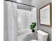 Bright white bathroom with a shower-tub and a modern plant accent at 2501 15Th St # 3F, Denver, CO 80211