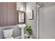 Modern bathroom featuring pedestal sink, framed mirror, shower, and plant at 2501 15Th St # 3F, Denver, CO 80211