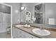 Bathroom with a dual sink vanity, white cabinetry, and a shower-tub combination at 2501 15Th St # 3F, Denver, CO 80211