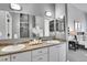 Bathroom with dual sinks and a large mirror; walk-in closet in background at 2501 15Th St # 3F, Denver, CO 80211