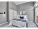 Stylish bedroom features a queen size bed, gray color scheme, closet, and access to a private balcony at 2501 15Th St # 3F, Denver, CO 80211