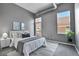 Stylish bedroom features a queen size bed, gray color scheme, with access to a private balcony at 2501 15Th St # 3F, Denver, CO 80211