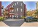 Modern condo building featuring private balconies, landscaping, and a parking area at 2501 15Th St # 3F, Denver, CO 80211