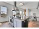 Well-lit kitchen featuring a central island, modern appliances, and a seamless connection to living spaces at 2501 15Th St # 3F, Denver, CO 80211