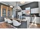 Stylish kitchen featuring an island with seating, stainless steel appliances, and modern finishes at 2501 15Th St # 3F, Denver, CO 80211