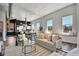 Spacious open-concept living room featuring hardwood floors, large windows, and modern decor at 2501 15Th St # 3F, Denver, CO 80211