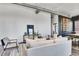 Bright living room with exposed ductwork and hardwood floors, blending modern style with cozy comfort at 2501 15Th St # 3F, Denver, CO 80211