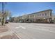 Commercial buildings featuring large windows and outdoor seating, lining a street with vehicle traffic and trees at 2501 15Th St # 3F, Denver, CO 80211