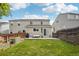 Spacious backyard with a well-maintained lawn, patio and tall wood fence at 21961 E Crestline Pl, Aurora, CO 80015