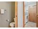 Bathroom featuring a toilet, sink, washer and dryer, and wood cabinets at 21961 E Crestline Pl, Aurora, CO 80015
