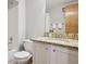 Bathroom featuring a marble countertop, white cabinetry, and updated fixtures at 21961 E Crestline Pl, Aurora, CO 80015