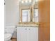 Modern bathroom featuring granite countertops, white cabinets and a stylish mirror at 21961 E Crestline Pl, Aurora, CO 80015