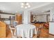 Bright dining area with hardwood floors, modern lighting, and seamless flow to the kitchen and living spaces at 21961 E Crestline Pl, Aurora, CO 80015