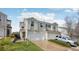 Two-story home with white siding, attached garages, and manicured lawn at 21961 E Crestline Pl, Aurora, CO 80015