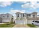 Two-story home with white siding, attached garages, and manicured lawn at 21961 E Crestline Pl, Aurora, CO 80015