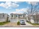 Two-story home with white siding, attached garages, and manicured lawn at 21961 E Crestline Pl, Aurora, CO 80015