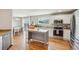 Bright kitchen with granite countertops, stainless appliances, and an island, leading to the dining area and backyard access at 21961 E Crestline Pl, Aurora, CO 80015