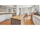 Stylish kitchen featuring granite counters, stainless steel appliances, an island, and an open layout into the dining room at 21961 E Crestline Pl, Aurora, CO 80015