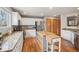 Bright kitchen with stainless appliances, granite countertops, and a convenient island, ideal for any home chef at 21961 E Crestline Pl, Aurora, CO 80015