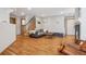 Open-concept living room with hardwood floors, fireplace, and staircase at 21961 E Crestline Pl, Aurora, CO 80015