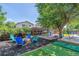 Charming backyard featuring a playset, fire pit area, and lush greenery, great for outdoor enjoyment at 3253 S Kalispell St, Aurora, CO 80013