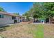 Large backyard features a deck with outdoor seating, mature trees, and plenty of space for recreation at 3253 S Kalispell St, Aurora, CO 80013