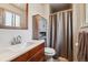 Bathroom features a wood vanity, modern sink and shower with neutral curtain at 3253 S Kalispell St, Aurora, CO 80013