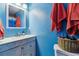 Bathroom featuring bright blue walls, an updated vanity and a decorative mirror at 3253 S Kalispell St, Aurora, CO 80013