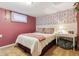 Inviting bedroom with queen bed, charming wallpaper, and soft lighting, for a cozy retreat at 3253 S Kalispell St, Aurora, CO 80013