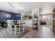 Inviting dining room with hardwood floors, an elegant chandelier, an open layout, and access to the kitchen and living area at 3253 S Kalispell St, Aurora, CO 80013