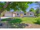 Well-maintained ranch home with brick and vinyl siding, solar panels, attached garage, and a manicured lawn at 3253 S Kalispell St, Aurora, CO 80013